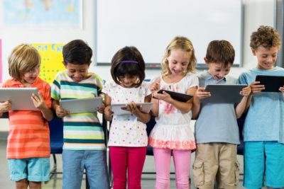 Children viewing computers or ipads.
